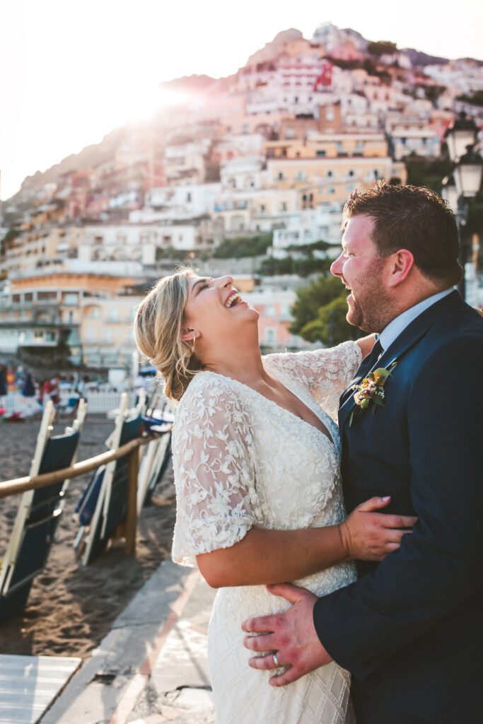 Newlyweds hug and laugh in Positano, Italy by elopement photographer Peggy Picot