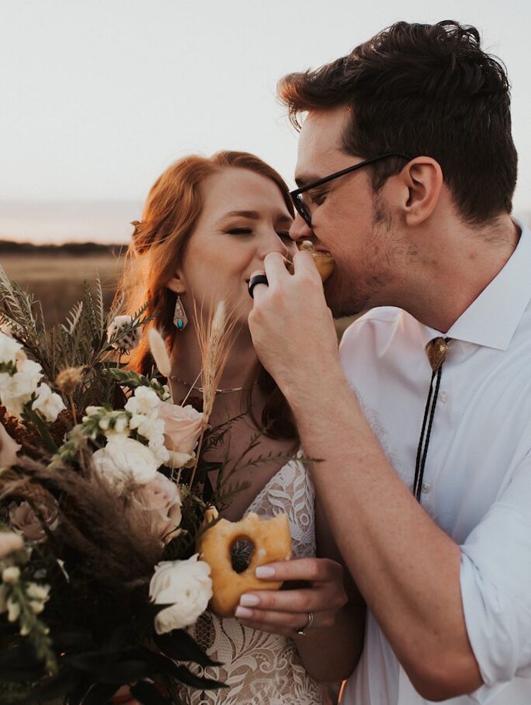 Florida Elopement Photographer Hazography - Art of Eloping. Newlyweds playfully feeding each other donuts.