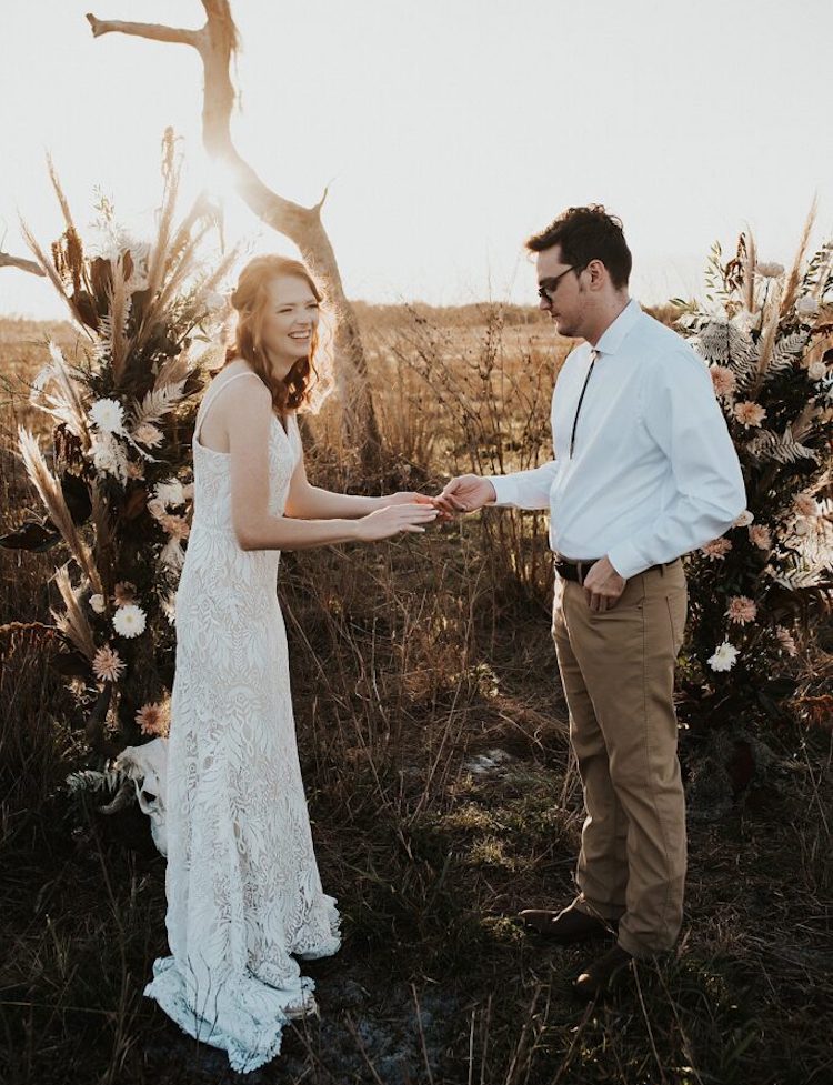 Florida Elopement Photographer Hazography - Art of Eloping. Couple exchanging rings at sunset in sand dune.